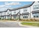 Exterior view of attractive brick and vinyl townhomes with covered entries and landscaped yards at 5712 Runnel Way, Charlotte, NC 28215