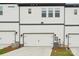 Modern townhouse with a white garage door, siding, and clean lines at 5712 Runnel Way, Charlotte, NC 28215