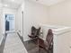 Hallway featuring a neutral color palette, decorative rug, and two stylish butterfly chairs at 5712 Runnel Way, Charlotte, NC 28215