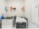 Functional laundry room with washer, dryer, and overhead shelving at 5712 Runnel Way, Charlotte, NC 28215