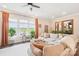 Bright living room features a large sectional, multiple windows, and hardwood flooring at 5712 Runnel Way, Charlotte, NC 28215