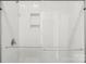 Modern shower with white tiles, glass doors, and a built-in shelf at 5712 Runnel Way, Charlotte, NC 28215