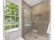 Updated bathroom with frameless shower, pebble floor, tiled walls and a shower niche at 5817 Portburn Rd, Charlotte, NC 28211
