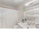 Bright bathroom with a white vanity, shower with curtain, and a large mirror for a clean and functional space at 5817 Portburn Rd, Charlotte, NC 28211
