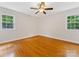 Empty bedroom with hardwood floors and large windows offering ample natural light at 5817 Portburn Rd, Charlotte, NC 28211