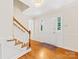 Inviting foyer with hardwood floors, staircase, and a well-lit entryway at 5817 Portburn Rd, Charlotte, NC 28211