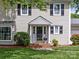 Close up of a home's entrance showcasing a brick pathway and attractive landscaping at 5817 Portburn Rd, Charlotte, NC 28211