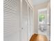 Hallway features louvered closet doors and a view into the adjacent bathroom with patterned tile at 5817 Portburn Rd, Charlotte, NC 28211