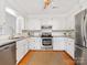 Bright kitchen with stainless steel appliances, white cabinetry and tiled backsplash at 5817 Portburn Rd, Charlotte, NC 28211