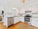 Well-lit kitchen with white cabinets, stainless steel appliances, and granite countertops at 5817 Portburn Rd, Charlotte, NC 28211
