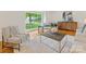 Bright and airy living room featuring hardwood floors, a large window, and stylish furniture at 5817 Portburn Rd, Charlotte, NC 28211