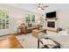 Comfortable living room featuring a fireplace, leather sofa, and neutral decor at 5817 Portburn Rd, Charlotte, NC 28211