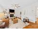 Bright living room features a brick fireplace, and ample seating with hardwood floors at 5817 Portburn Rd, Charlotte, NC 28211