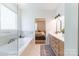 Elegant bathroom with marble finishes, a luxurious soaking tub, and double sink vanity at 602 Kames Nw Ct, Conover, NC 28613