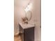 Clean bathroom featuring a dark vanity, a round mirror, and modern fixtures for a sleek look at 602 Kames Nw Ct, Conover, NC 28613