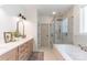 Contemporary bathroom boasts a glass-enclosed shower, soaking tub, and double sink vanity at 602 Kames Nw Ct, Conover, NC 28613