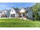 Charming home featuring a black garage door, front porch swing, and manicured lawn at 602 Kames Nw Ct, Conover, NC 28613