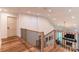 Upstairs hallway with wooden floor and black railings with fireplace views at 602 Kames Nw Ct, Conover, NC 28613