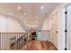 Second story hallway with wooden floor and black railings overlooking a living area at 602 Kames Nw Ct, Conover, NC 28613