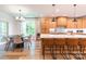 Open kitchen and dining area featuring wood cabinets, a large island, and stainless steel appliances at 602 Kames Nw Ct, Conover, NC 28613