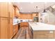 Bright kitchen with wood cabinets, a large island, and an open design leading to the staircase at 602 Kames Nw Ct, Conover, NC 28613