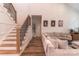 Bright living room showcasing a staircase, comfortable seating, and stylish decor for a welcoming atmosphere at 602 Kames Nw Ct, Conover, NC 28613