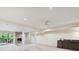 Basement including stone fireplace, bar area, sliding doors to a deck, and neutral-colored carpet at 6645 Gaywind Dr, Charlotte, NC 28226
