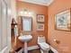 Charming half-bath features a pedestal sink and decorative artwork at 6645 Gaywind Dr, Charlotte, NC 28226