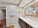 Bathroom with long vanity, large framed mirror, and hardwood floors at 6645 Gaywind Dr, Charlotte, NC 28226
