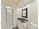 Well-lit bathroom featuring a walk-in shower, modern vanity, and coordinated fixtures at 6645 Gaywind Dr, Charlotte, NC 28226