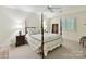 Bedroom featuring a four-poster bed, neutral walls, and carpet, creating a serene retreat at 6645 Gaywind Dr, Charlotte, NC 28226