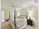 Bedroom featuring a four poster bed, carpet flooring, ceiling fan, lamps and side tables at 6645 Gaywind Dr, Charlotte, NC 28226
