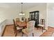 Formal dining room featuring a large wooden table, decorative chairs, and a stylish china cabinet at 6645 Gaywind Dr, Charlotte, NC 28226