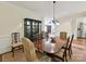 Dining room featuring a wooden table with upholstered chairs, a china cabinet, and an elegant chandelier at 6645 Gaywind Dr, Charlotte, NC 28226