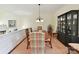 Formal dining room with ample seating, elegant lighting, and a classic china cabinet at 6645 Gaywind Dr, Charlotte, NC 28226