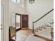 Stunning foyer boasts hardwood floors, staircase, and a beautiful front door with transom windows at 6645 Gaywind Dr, Charlotte, NC 28226