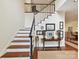 Elegant foyer with a staircase, hardwood floors, and tasteful decorations, creating a warm and welcoming atmosphere at 6645 Gaywind Dr, Charlotte, NC 28226
