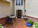 Inviting brick front porch with stylish seating creates a welcoming entrance to the home at 6645 Gaywind Dr, Charlotte, NC 28226