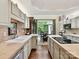 Well-lit kitchen features tile backsplash, stone countertops, stainless steel appliances, and a seamless transition to the outdoors at 6645 Gaywind Dr, Charlotte, NC 28226