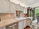 Kitchen featuring stone countertops, tiled backsplash, stainless steel appliances, and seamless transition to an outdoor area at 6645 Gaywind Dr, Charlotte, NC 28226