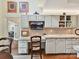 Kitchen features white cabinetry, tile countertops, and a convenient desk area at 6645 Gaywind Dr, Charlotte, NC 28226