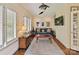 Cozy living room featuring plantation shutters, a ceiling fan, and wood flooring at 6645 Gaywind Dr, Charlotte, NC 28226