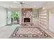 Inviting living room featuring a stone fireplace, built-in shelves, and a sliding door to the outdoor deck at 6645 Gaywind Dr, Charlotte, NC 28226
