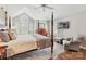 Comfortable main bedroom with four poster bed, vaulted ceilings and television at 6645 Gaywind Dr, Charlotte, NC 28226