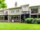 The rear of the home displays multiple decks, a lush lawn, and mature landscaping, perfect for outdoor enjoyment at 6645 Gaywind Dr, Charlotte, NC 28226