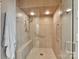 Tiled shower stall with glass door, seat and chrome fixtures at 6645 Gaywind Dr, Charlotte, NC 28226