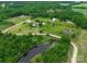 Aerial view of the acreage featuring a pond and tree-lined property at 6813 Rebel Rd, Marshville, NC 28103
