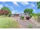 The spacious backyard includes a covered patio area, mature trees, and a view of a storage building at 6813 Rebel Rd, Marshville, NC 28103