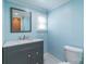 Charming bathroom features a gray vanity with a marble countertop, a square mirror and baby blue walls at 6813 Rebel Rd, Marshville, NC 28103