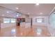 Bright, open-concept living space with hardwood floors, ceiling fan, and view to kitchen at 6813 Rebel Rd, Marshville, NC 28103